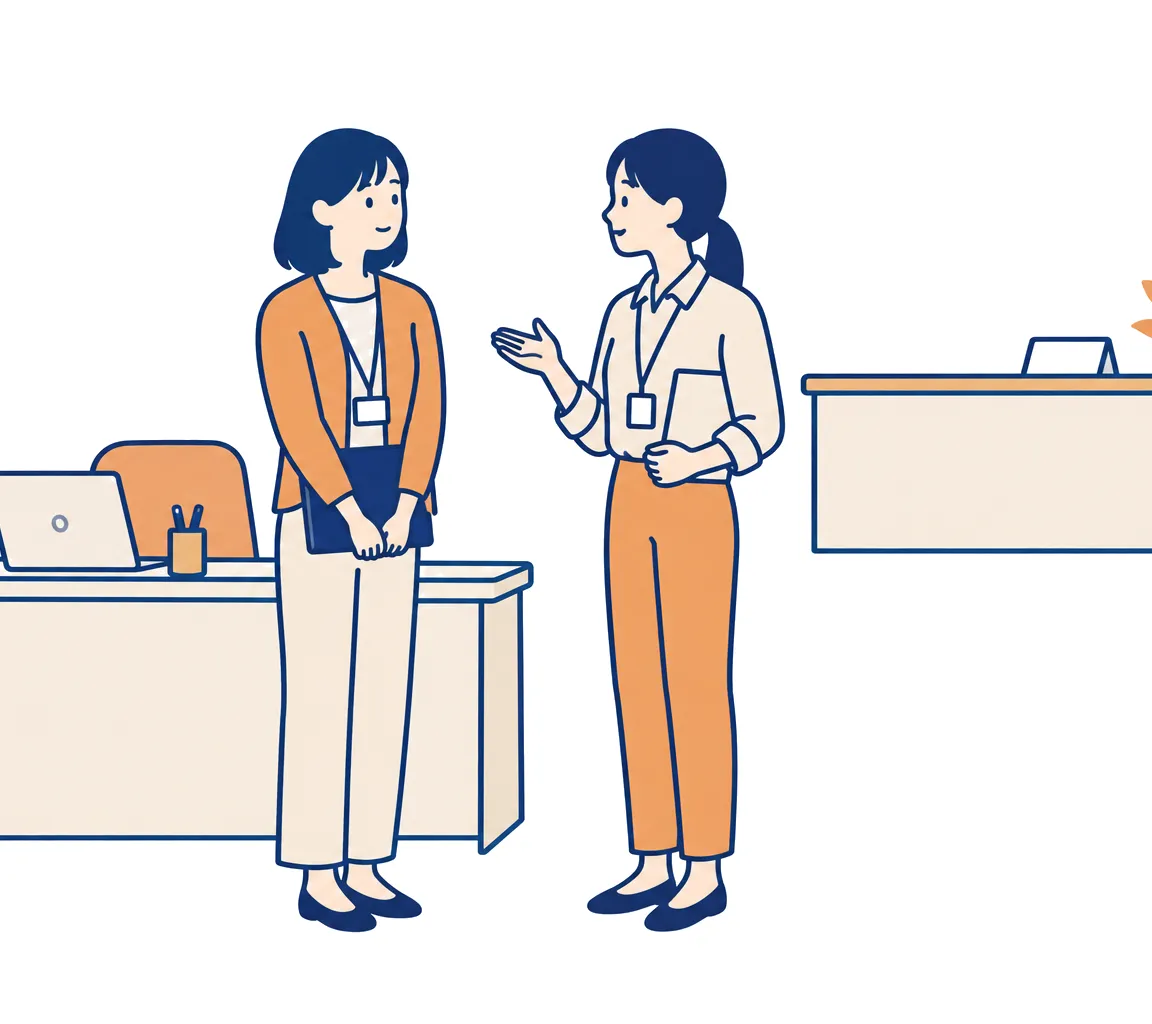 席まで来た社員の相談を立ったまま聞いている担当者と、空いたままの問い合わせ窓口