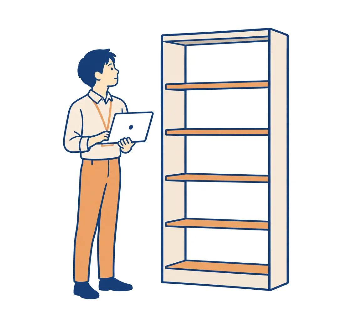 空の書類棚の前で、担当者がノートPCを開いて何を読ませるか考えている